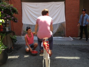Anne Dee Huk's work: a strawberry canon attached to a bike, which guests can use to shoot fruit on to a white surface.